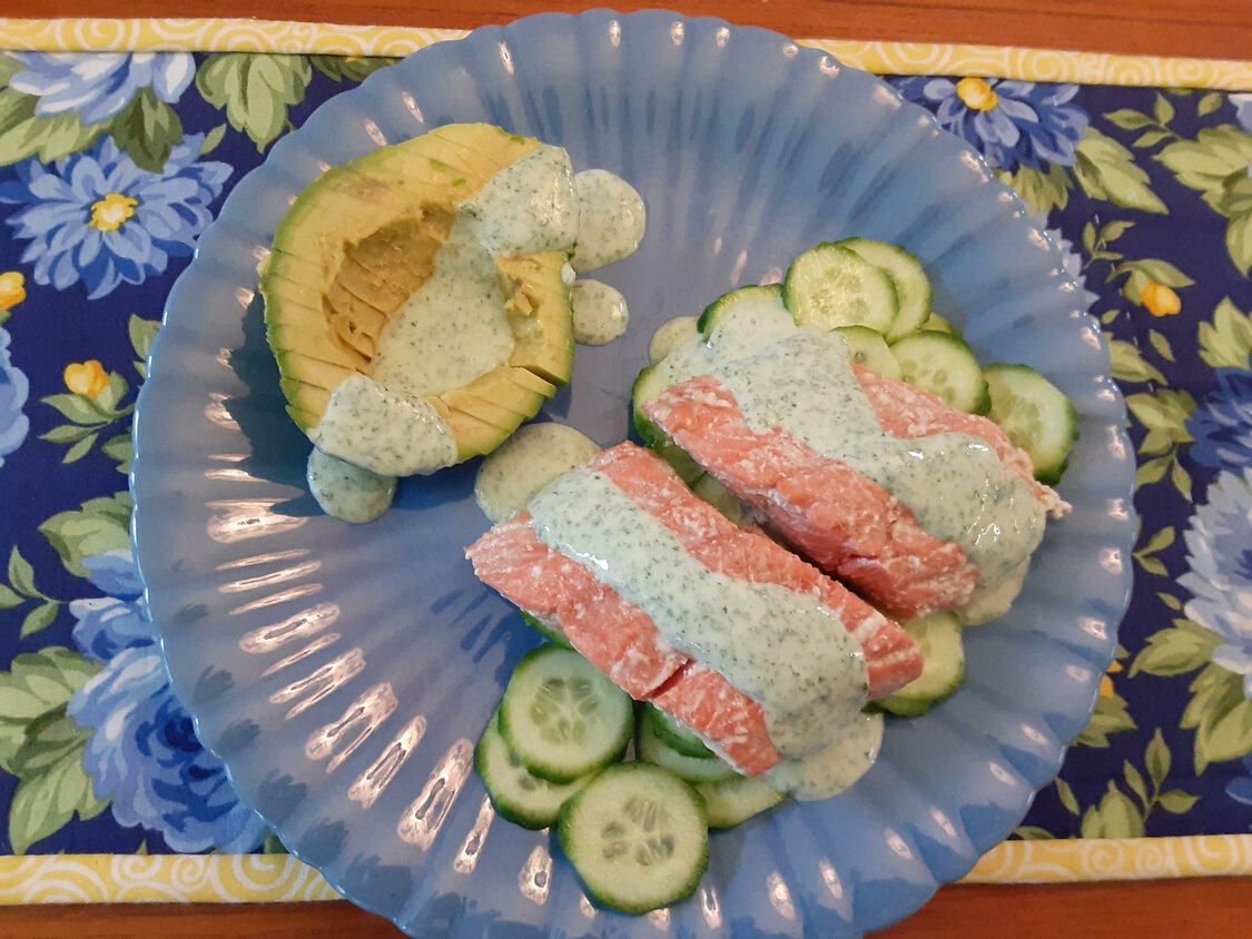 Poached salmon with cilantro mint sauce, cucumbers and avocado